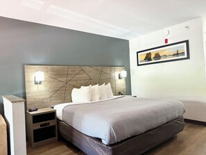 Premium bedding, desk, laptop workspace, blackout drapes
