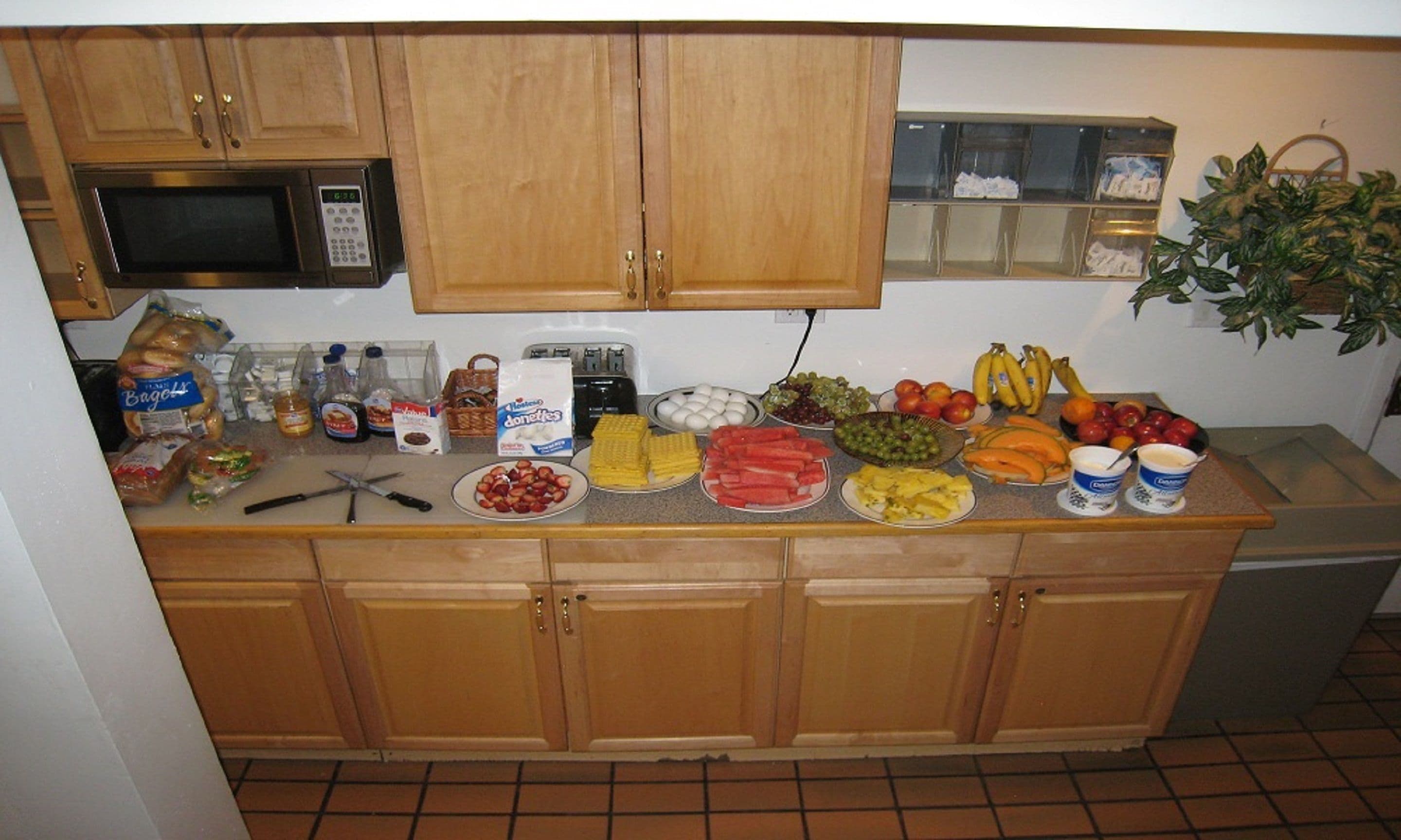 A kitchen counter with various food items and kitchen appliances.