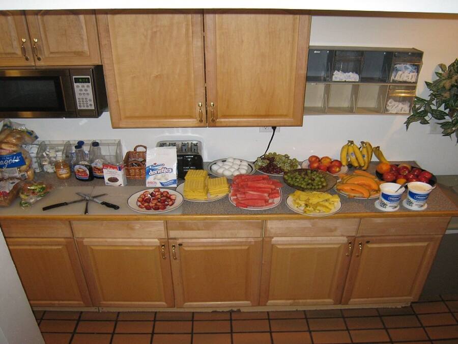 A kitchen counter with various food items and kitchen appliances.