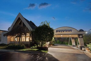Experience the sleek, modern design of this hotel, featuring a striking triangular roof and beautifully maintained grounds.