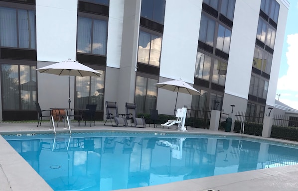 Piscine extérieure en saison, chaises longues