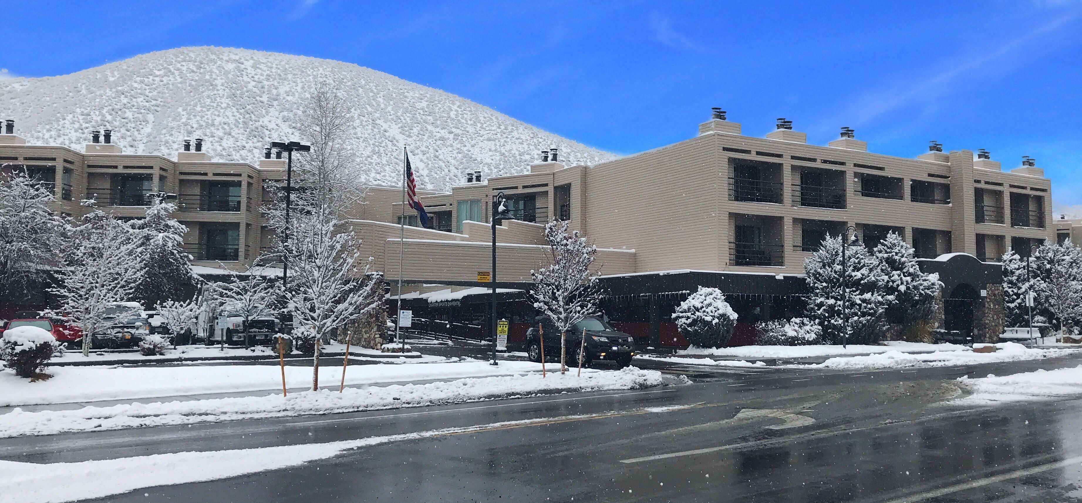 A hotel with a modern design, featuring a flat roof and large windows.