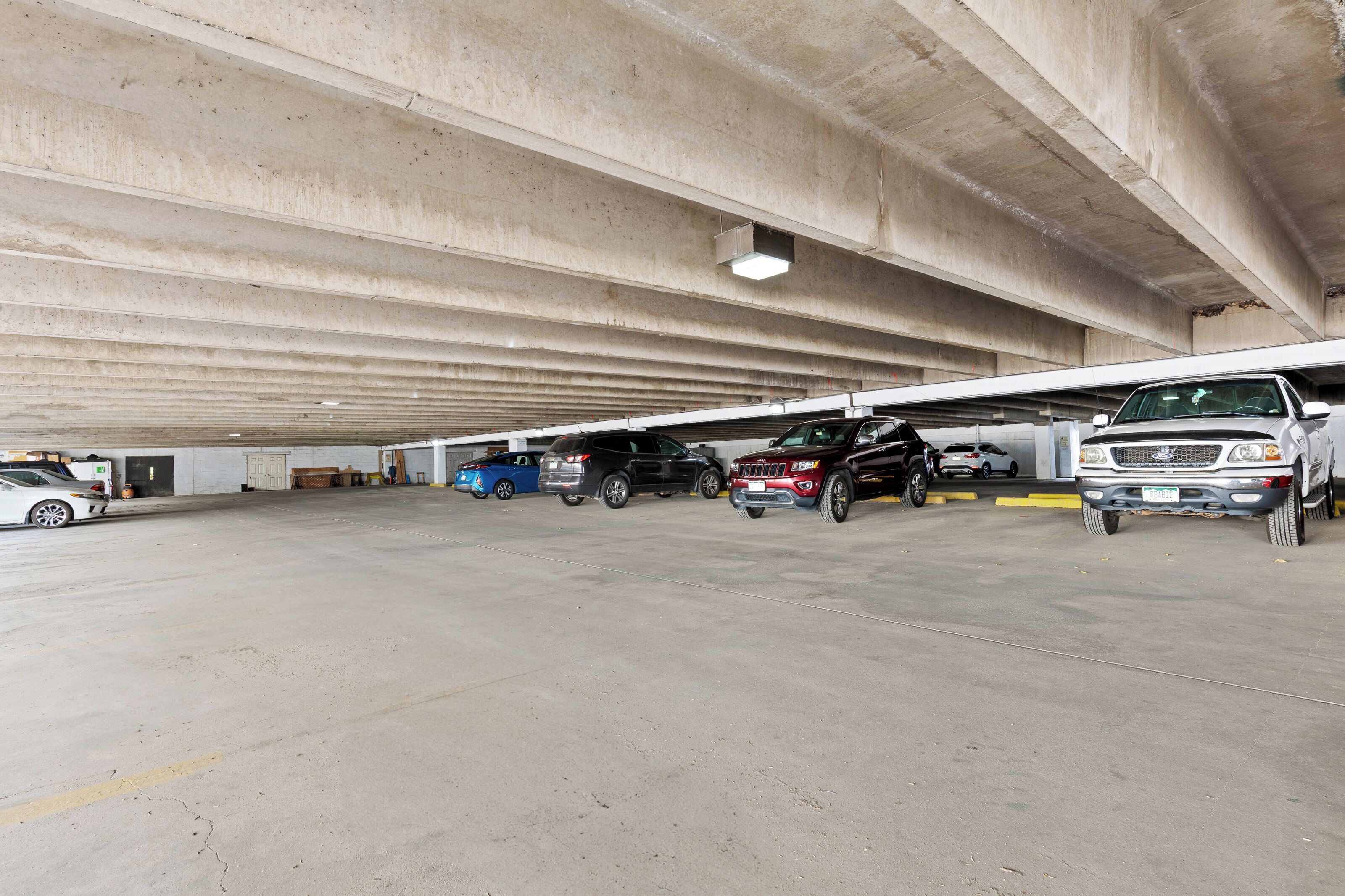 A multi-level parking garage with several cars parked on different levels.