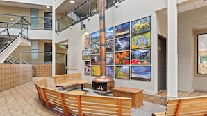 A lobby with a fireplace, wooden benches, and a staircase. - The Christie Lodge - All Suite Property, Vail Valley/Beaver Creek (Avon)