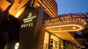 The exterior of the Georgian Court Hotel with a prominent entrance and illuminated signage.