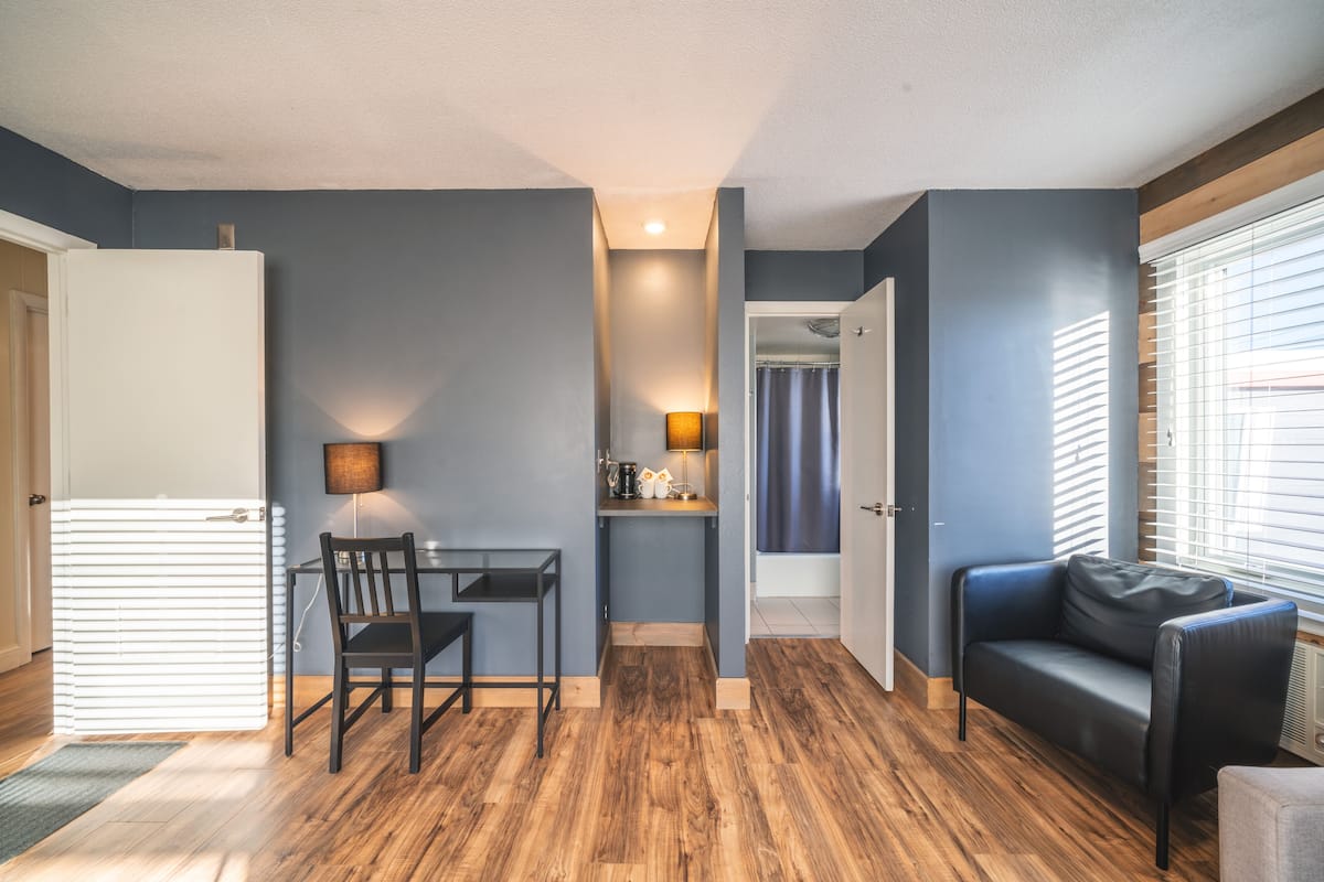 A compact living space with a kitchenette, a dining area, and a seating area.