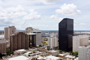 A cityscape with various high-rise buildings, including a prominent black glass skyscraper.