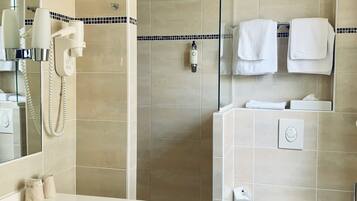 Une salle de bain moderne équipée d’un lavabo, de toilettes et d’une zone douche.
