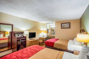 A hotel room with two beds, a desk with a computer, a microwave, and a TV. - Econo Lodge Huntington - Barboursville University Area (Huntington)