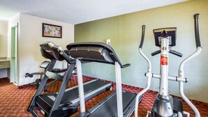 A gym with treadmills and an elliptical machine.