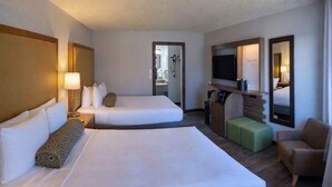 A hotel room with two beds, a TV, a seating area, and a mirror. - The Dalles Inn (The Dalles)