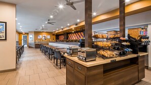 A modern breakfast bar with seating, a coffee machine, and a pastry display. - Best Western Plus Park Place Inn - Mini Suites (Anaheim)