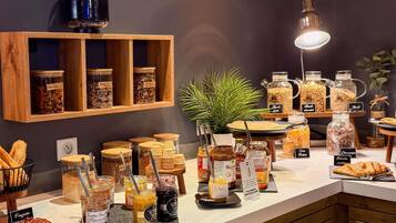 A breakfast buffet with various food items and condiments.