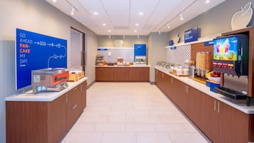 A modern breakfast area with a digital menu display, a bakery section, and a cereal dispenser.