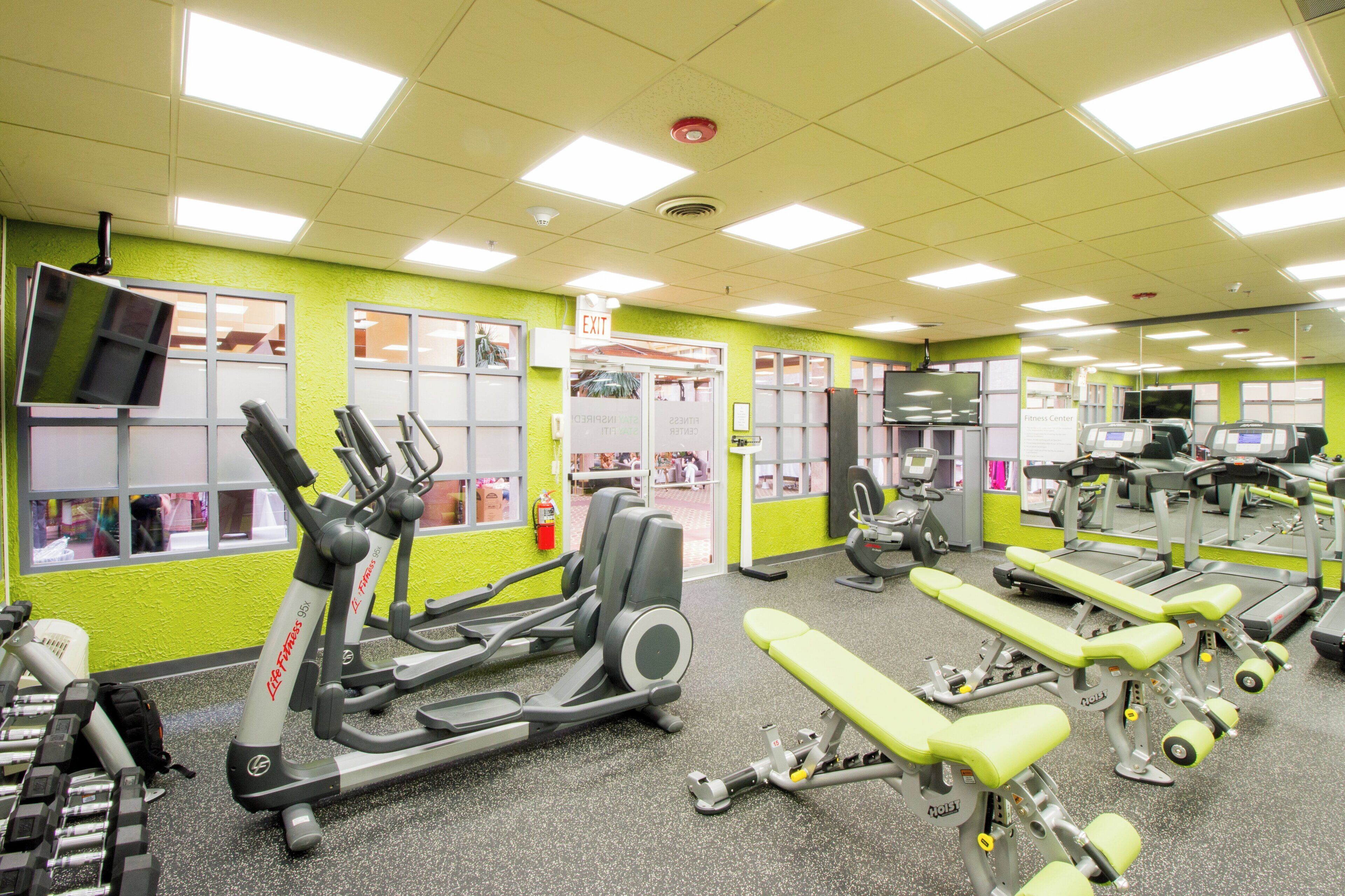 A gym with various exercise equipment, including treadmills and weight machines.
