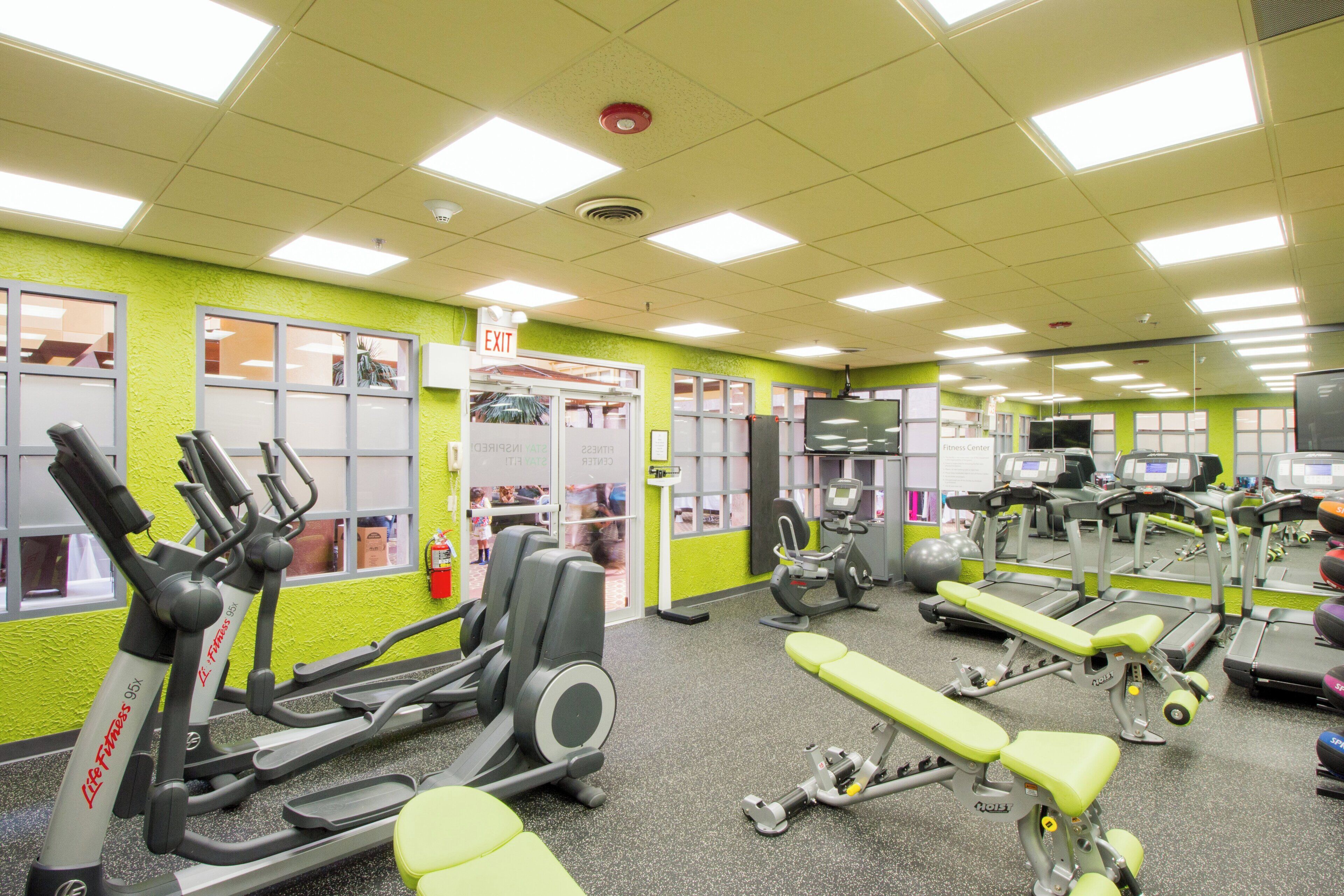 A gym with various exercise equipment, including treadmills and weight machines.