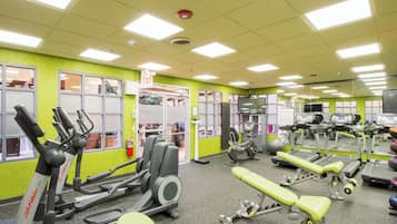 A gym with various exercise equipment, including treadmills and weight machines.