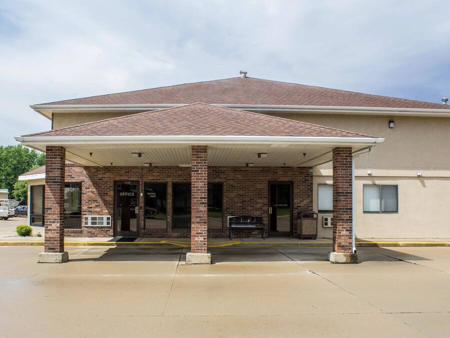 A two-story building with a covered entrance and a brick facade.