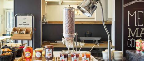 A breakfast buffet with various food items and beverages.