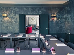 A conference room with a long table, chairs, and a red accent chair. - Mercure Nancy Centre Place Stanislas Hotel (Nancy)