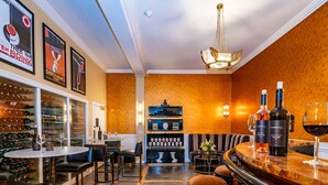 A bar area with a wine rack, seating, and a bar counter. - Mount View Hotel & Spa (Calistoga)