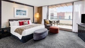 A hotel room with a large bed, a chair, a small table, and a TV. - Crowne Plaza Auckland by IHG (Auckland)