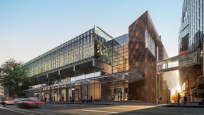 A modern building with a glass facade, large windows, and a pedestrian walkway. - Crowne Plaza Auckland by IHG (Auckland)