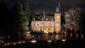 A historic building with a central tower, arched windows, and a symmetrical facade. - Brownsover Hall Hotel  (Rugby)