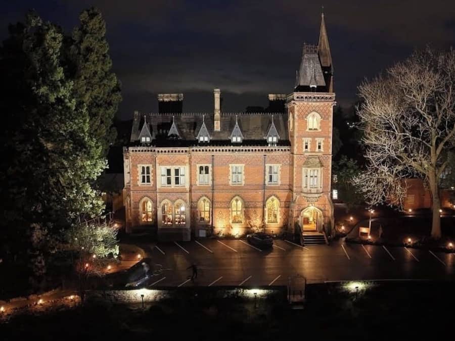 A historic building with a central tower, arched windows, and a symmetrical facade.