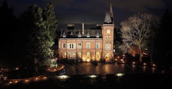 A historic building with a central tower, arched windows, and a symmetrical facade.