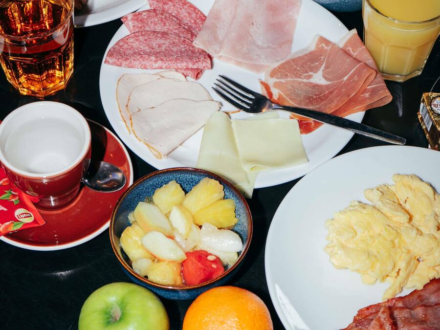 A breakfast setting with various food items and a beverage.