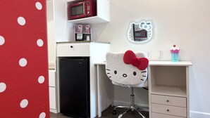 A compact kitchenette with a microwave, refrigerator, and a Hello Kitty-themed chair. - The Dixie Hollywood (Los Angeles)