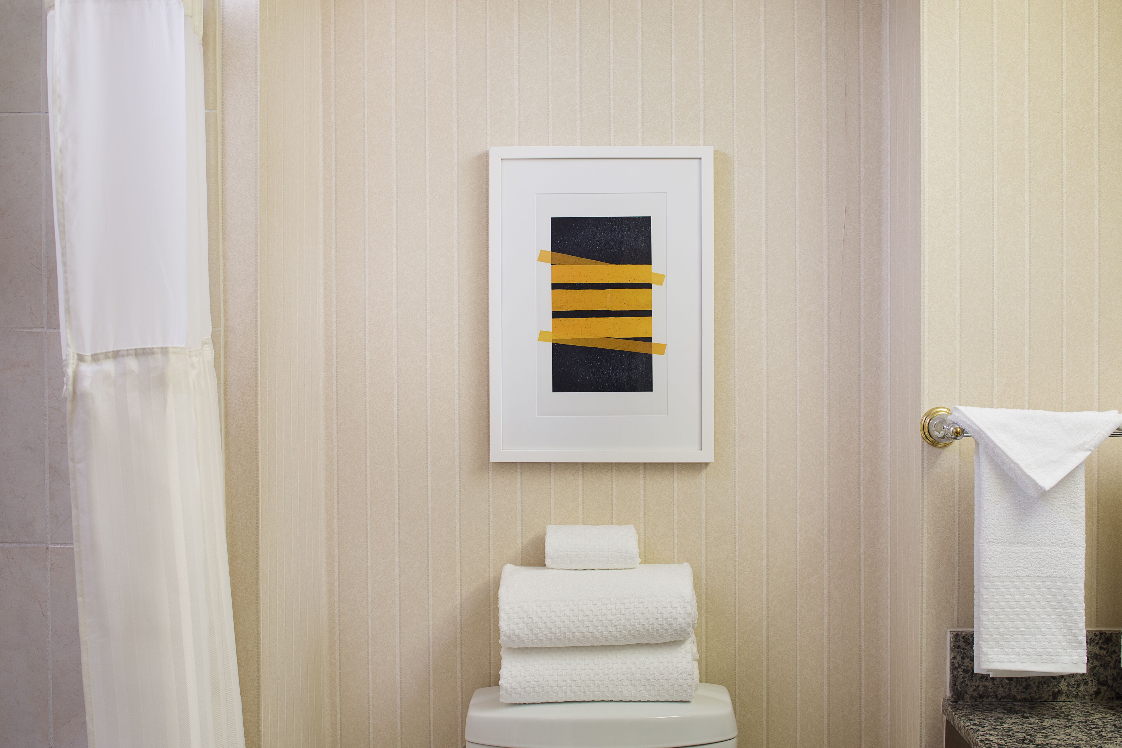 combined shower/bathtub, designer toiletries, hair dryer, towels