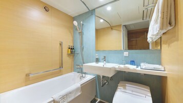 Un baño moderno con bañera, ducha y lavamanos.