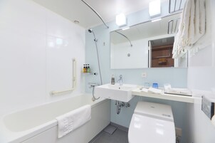A modern bathroom with a bathtub, a sink, and a toilet.