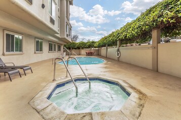 Outdoor pool, open 10:00 AM to 10:00 PM, pool loungers