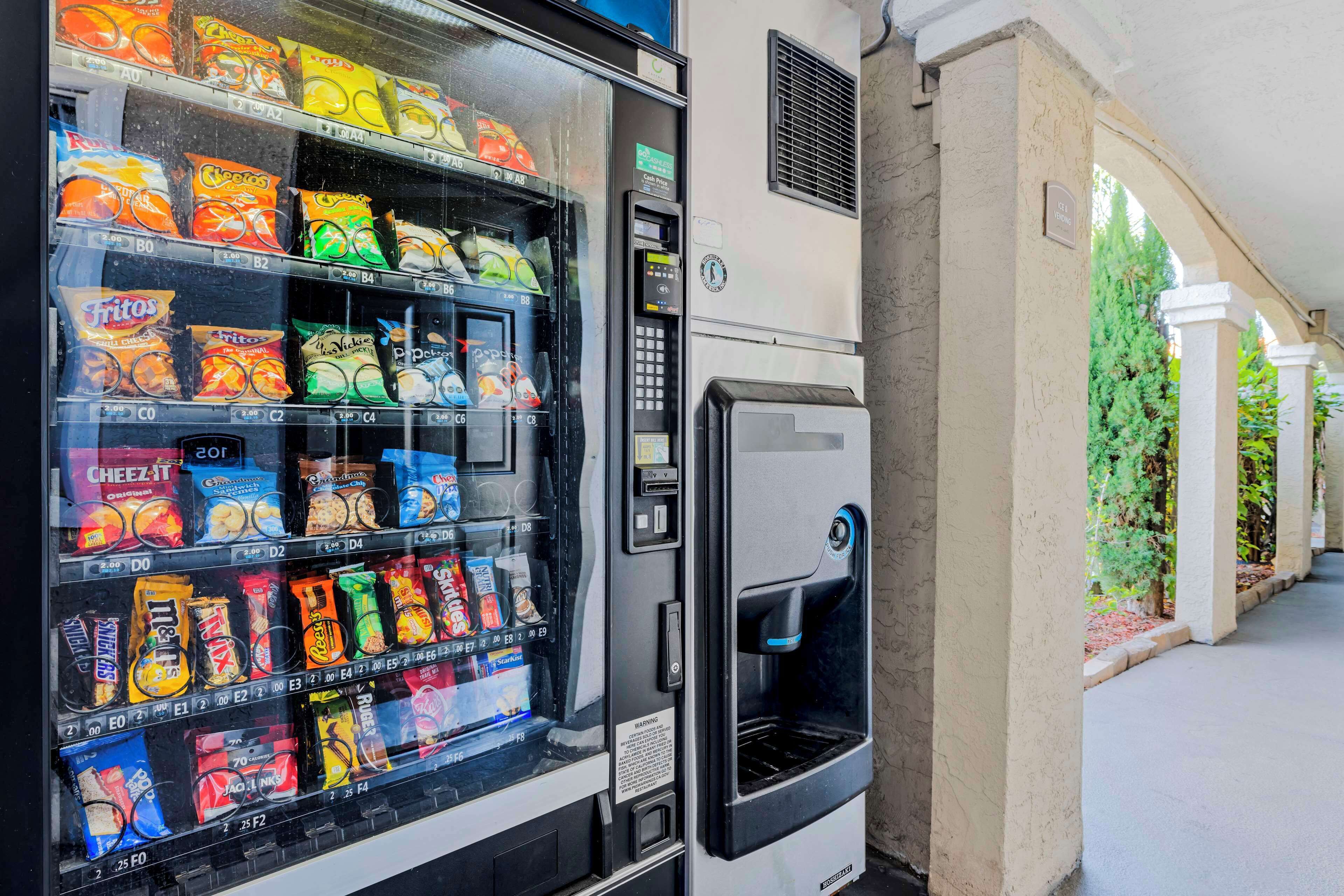 A vending machine stocked with snacks and a water dispenser.