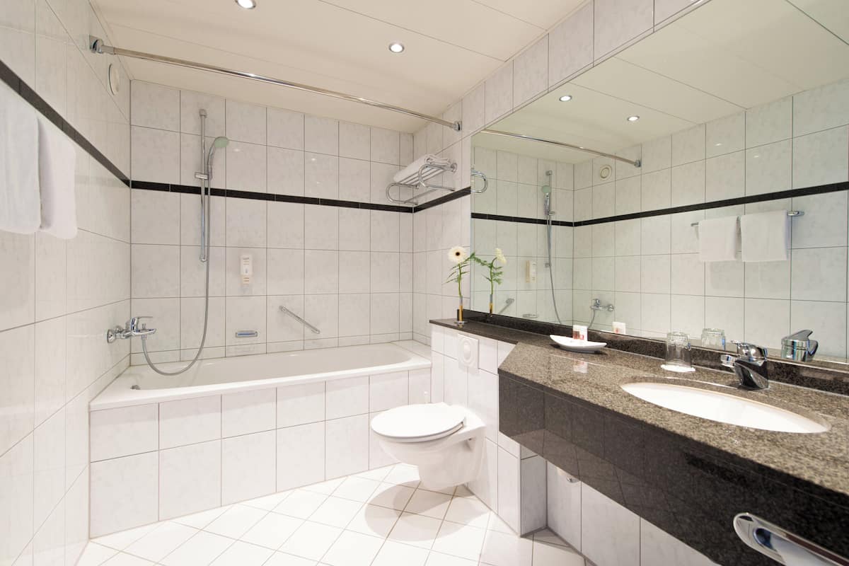 bathtub, eco-friendly toiletries, hair dryer, towels