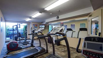 A gym with treadmills, elliptical machines, and weight equipment.