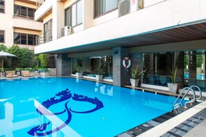 Outdoor pool, open 7:00 AM to 7:00 PM, pool umbrellas, pool loungers