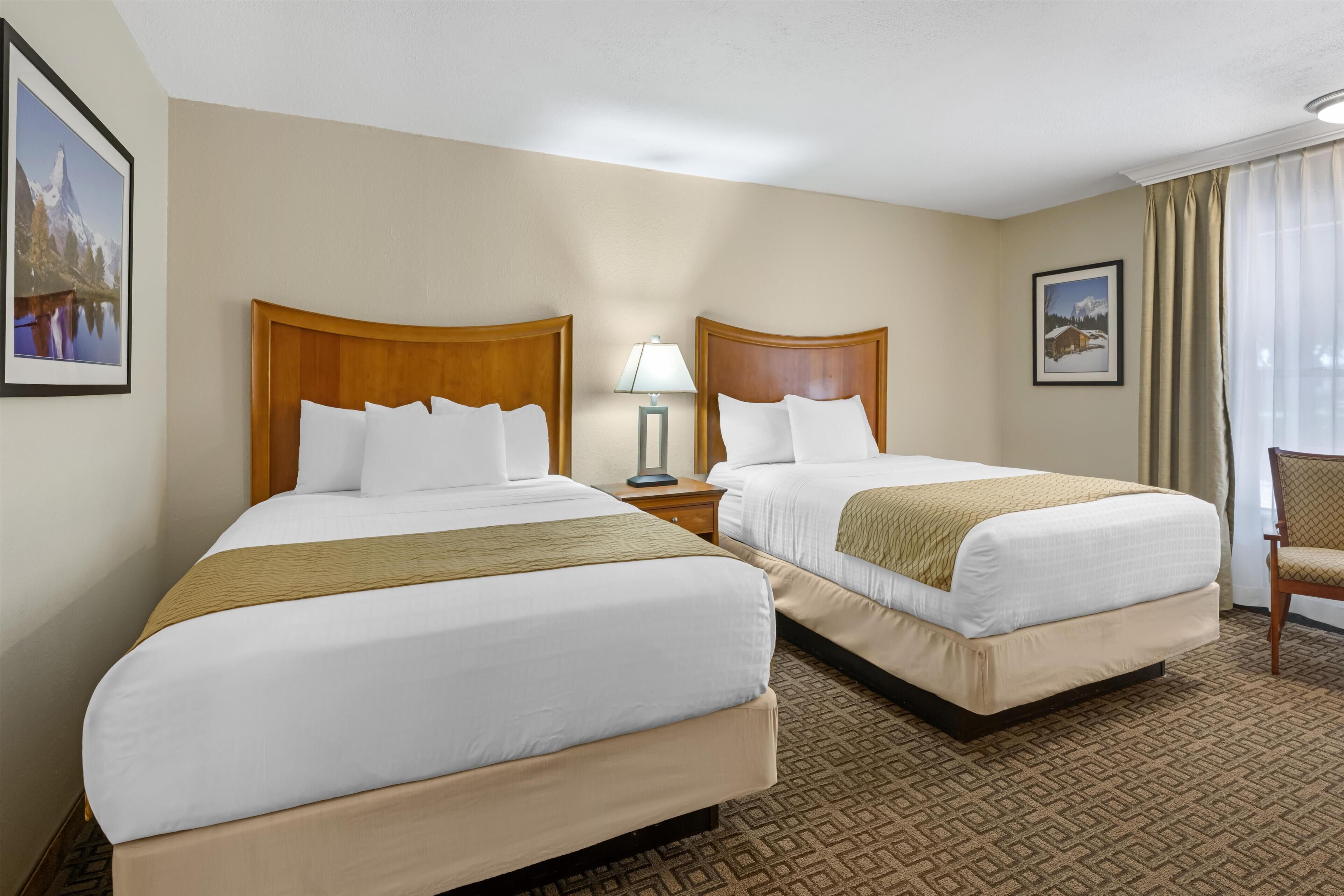 Premium bedding, pillow-top beds, laptop workspace, iron/ironing board