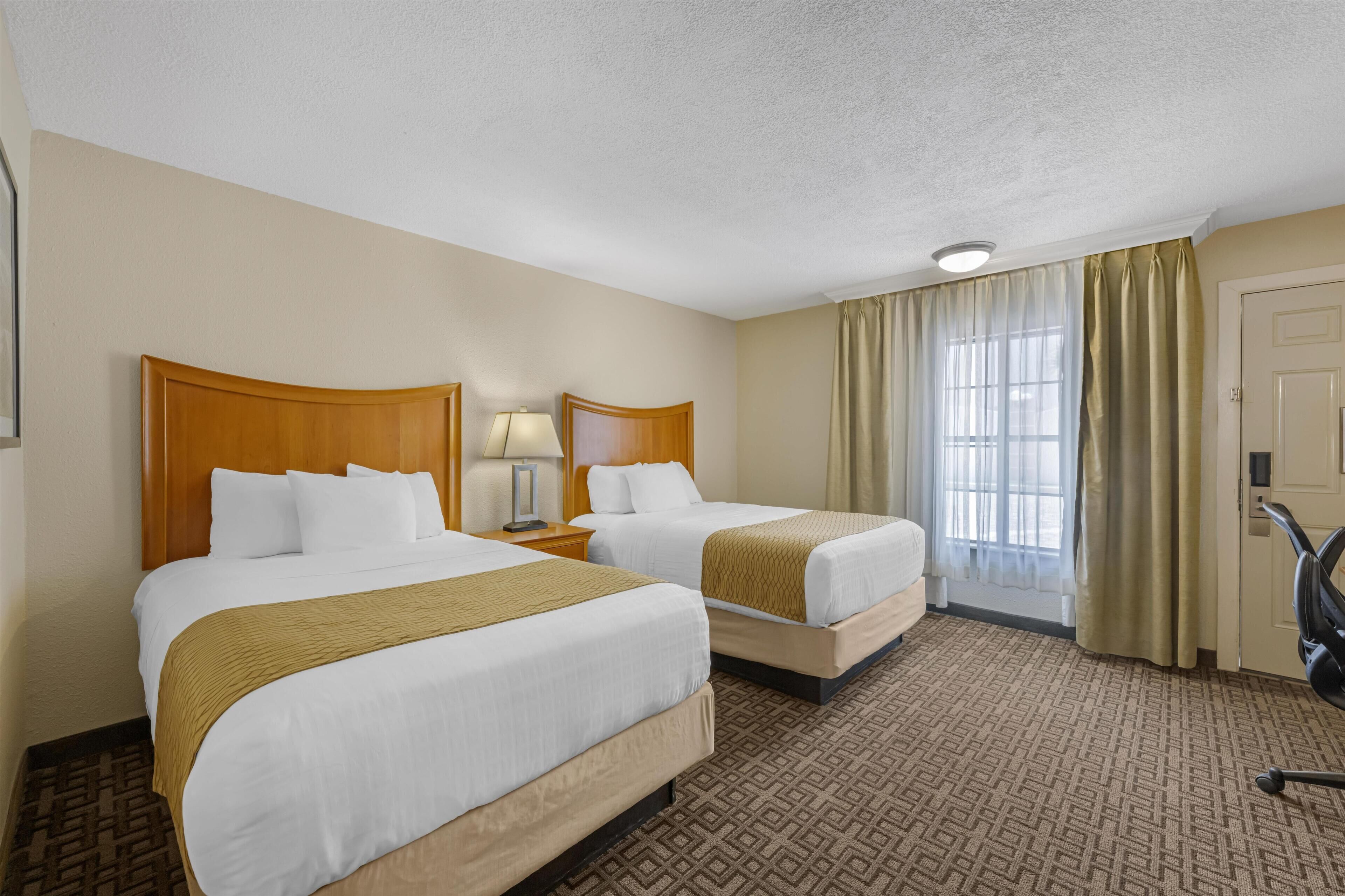 Premium bedding, pillow-top beds, laptop workspace, iron/ironing board