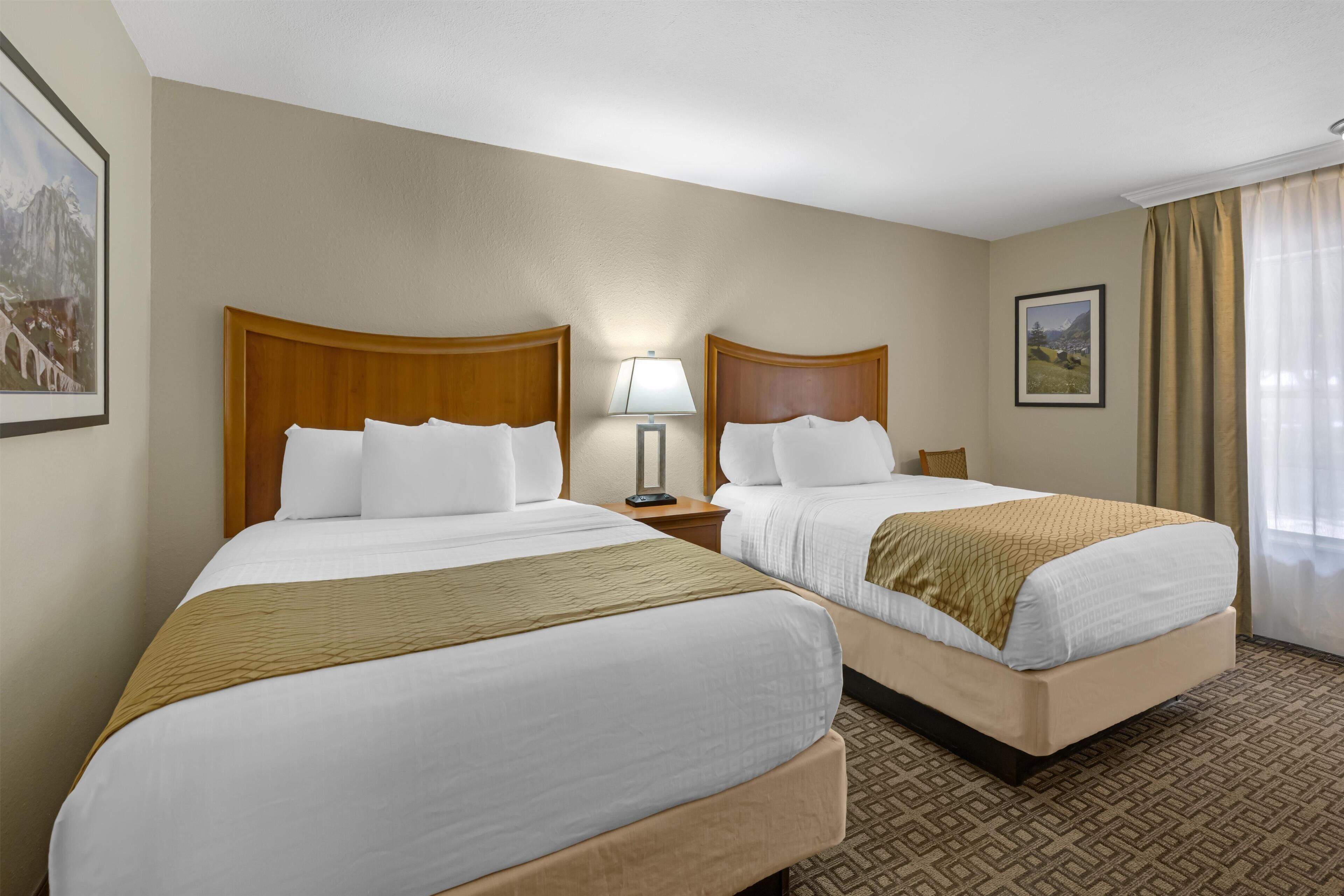 Premium bedding, pillow-top beds, laptop workspace, iron/ironing board