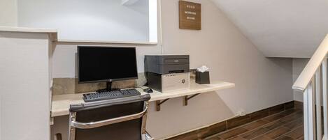 A modern office with a desk, computer, and chair.