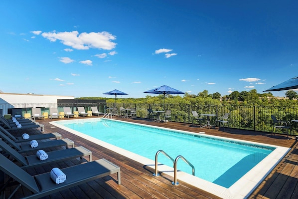 Seasonal outdoor pool, open 9:00 AM to 9:00 PM, pool umbrellas