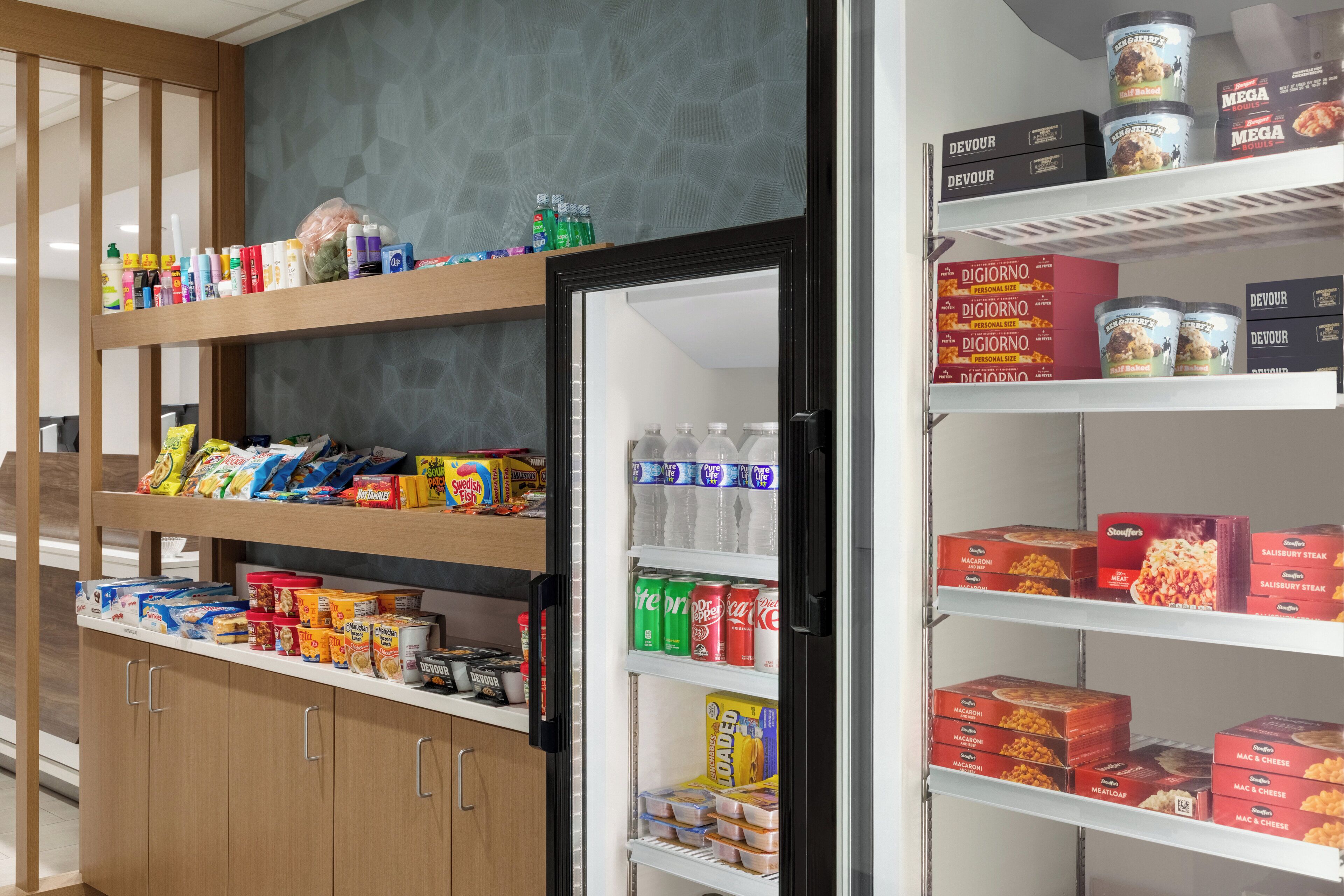 A refrigerated display with various food items including cereals, snacks, and beverages.
