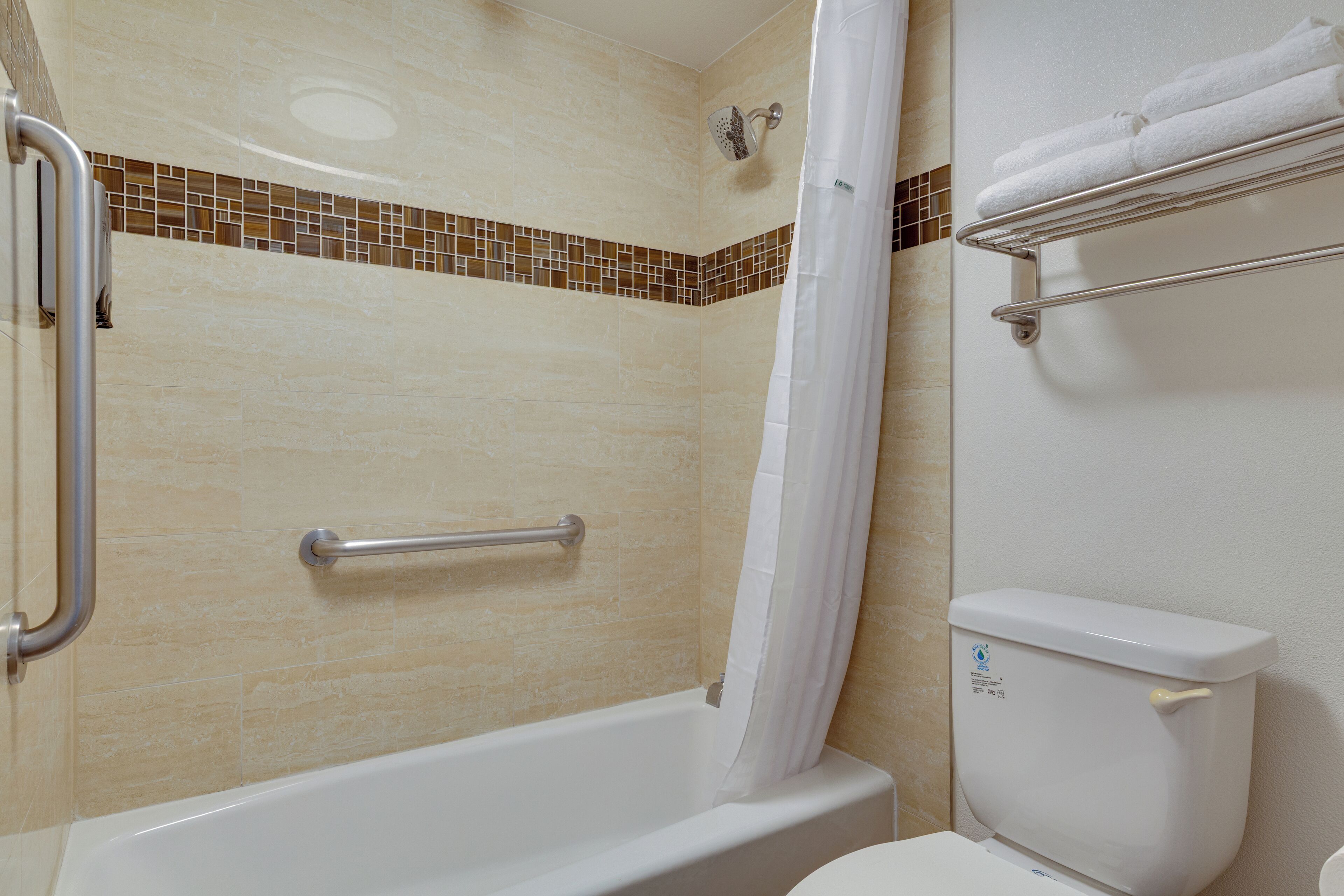 A bathroom with a bathtub, a shower, and a toilet.