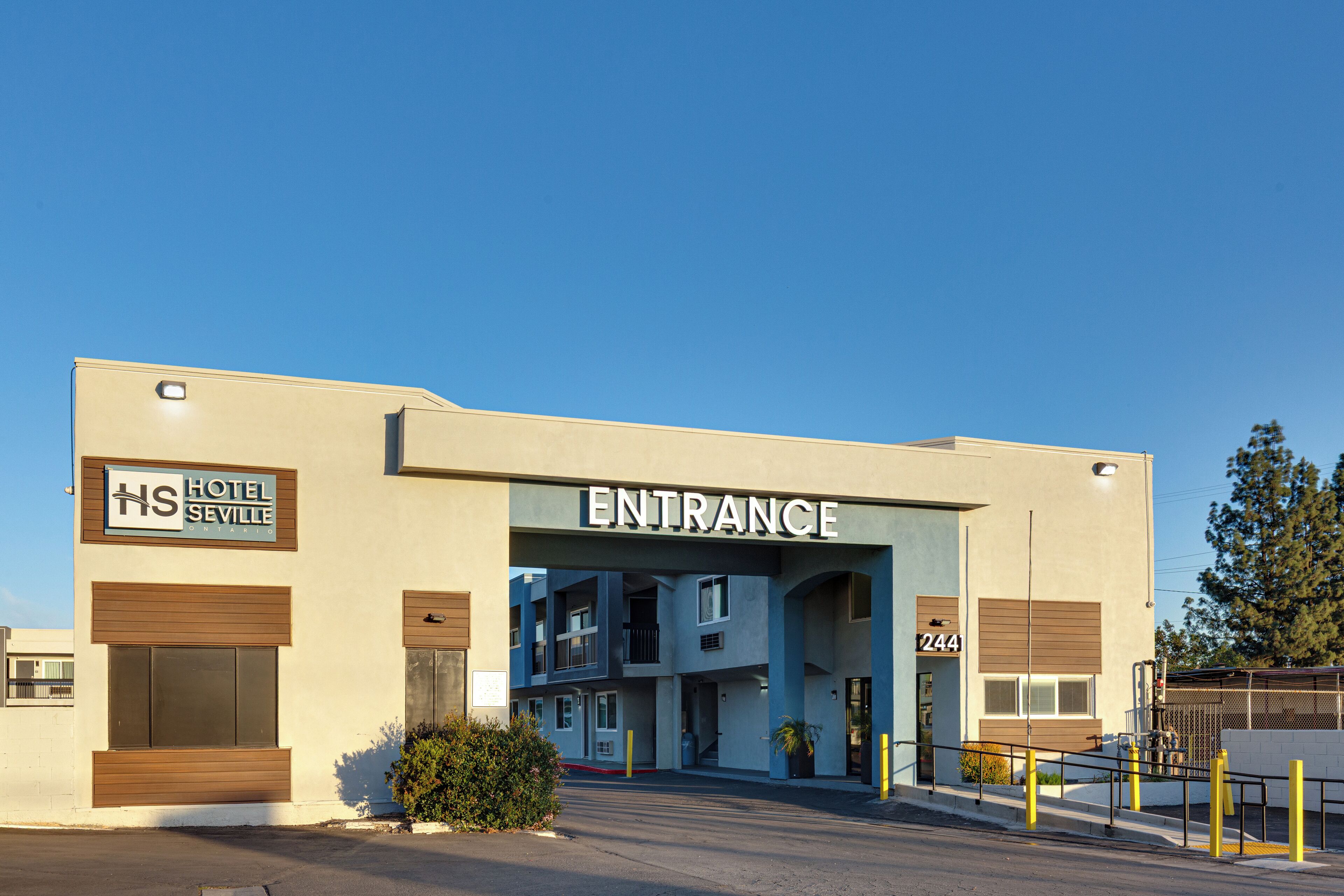 A hotel entrance with a sign reading "HOTEL SEVILLE" and the number "244" on the building.