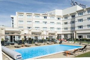 Seasonal outdoor pool, open 8:00 AM to 9:00 PM, pool umbrellas