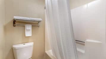 A bathroom with a toilet, a towel rack, and a shower curtain.